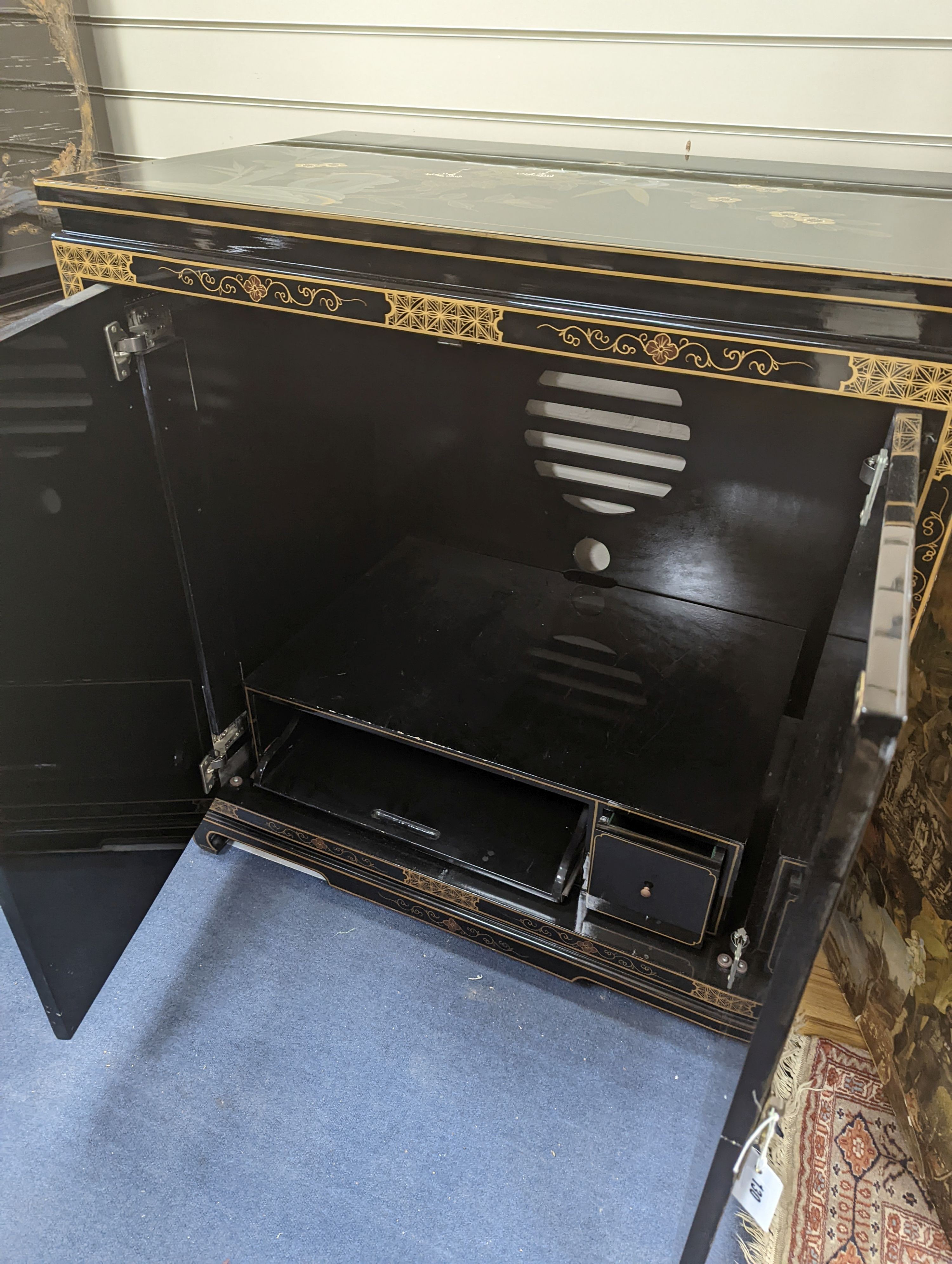 A Chinese lacquer media cabinet. W-94cm, D-61cm, H-102cm.